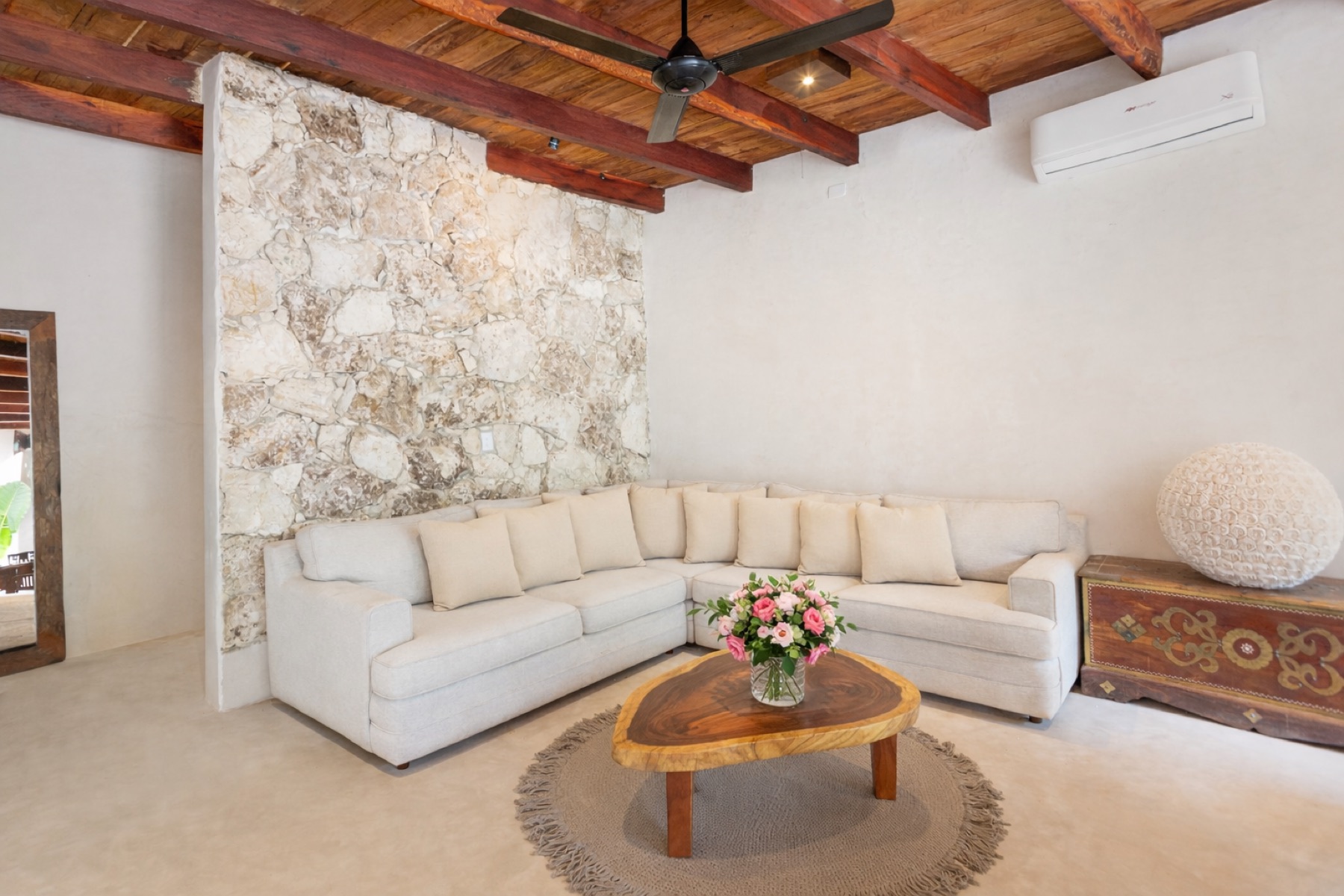 Casa Shanti living room with stone wall – Amansala Tulum