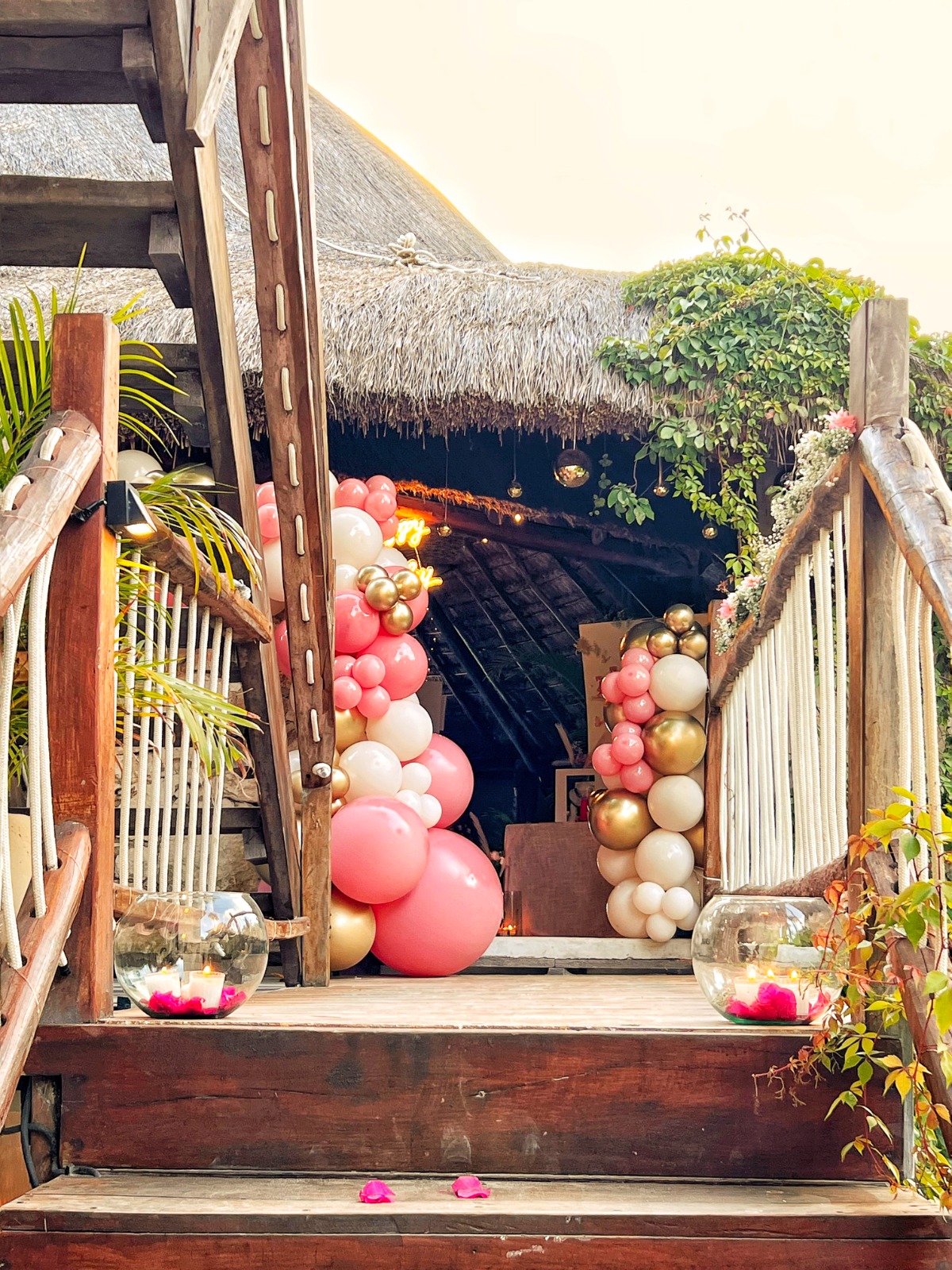 Pink, white and gold balloon garland entrance to a birthday celebration