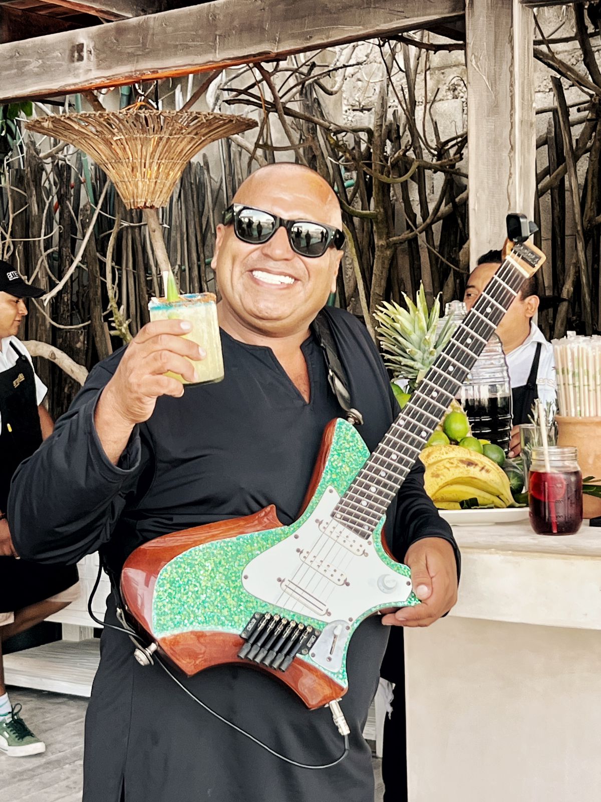 Live guitarist toasting with guests at an Amansala celebration