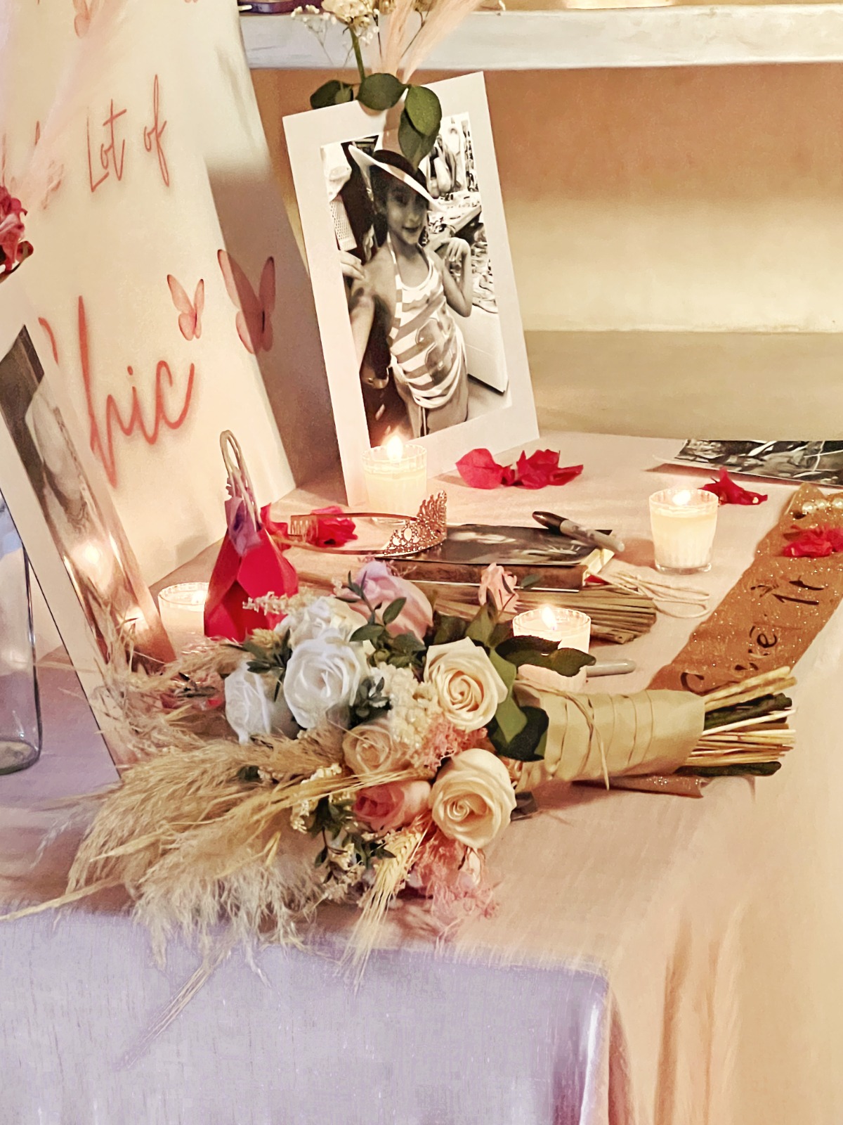 Birthday memory table with photos, candles and flowers