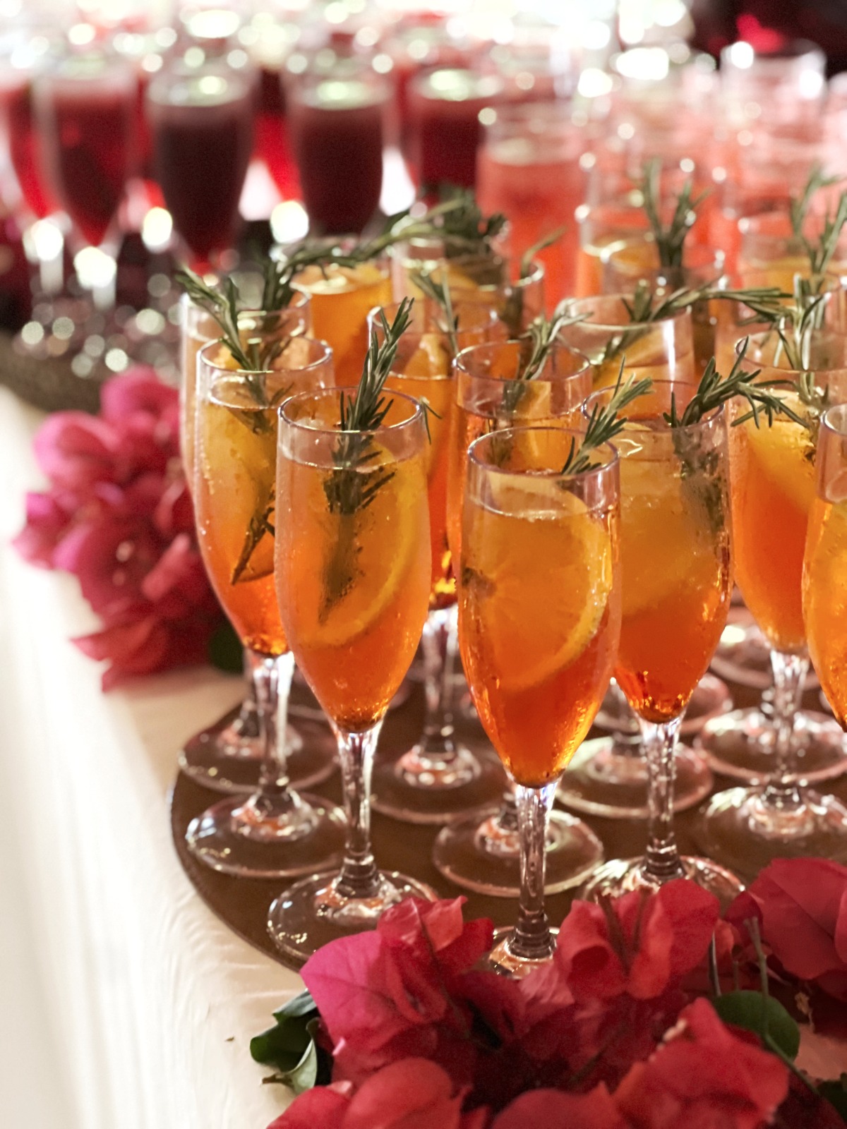 Orange cocktails garnished with rosemary at a birthday celebration