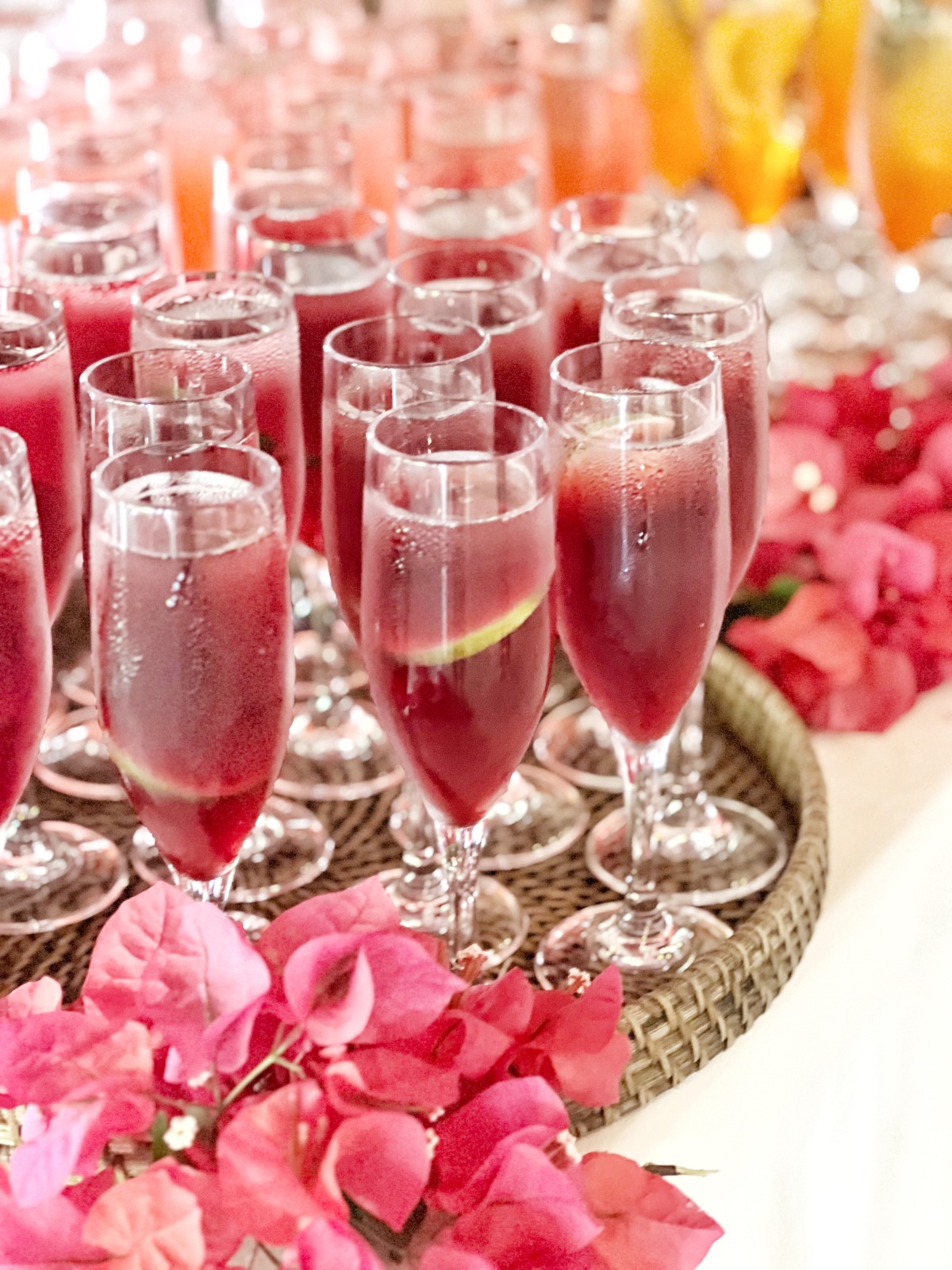 Pink celebration cocktails garnished with bougainvillea petals