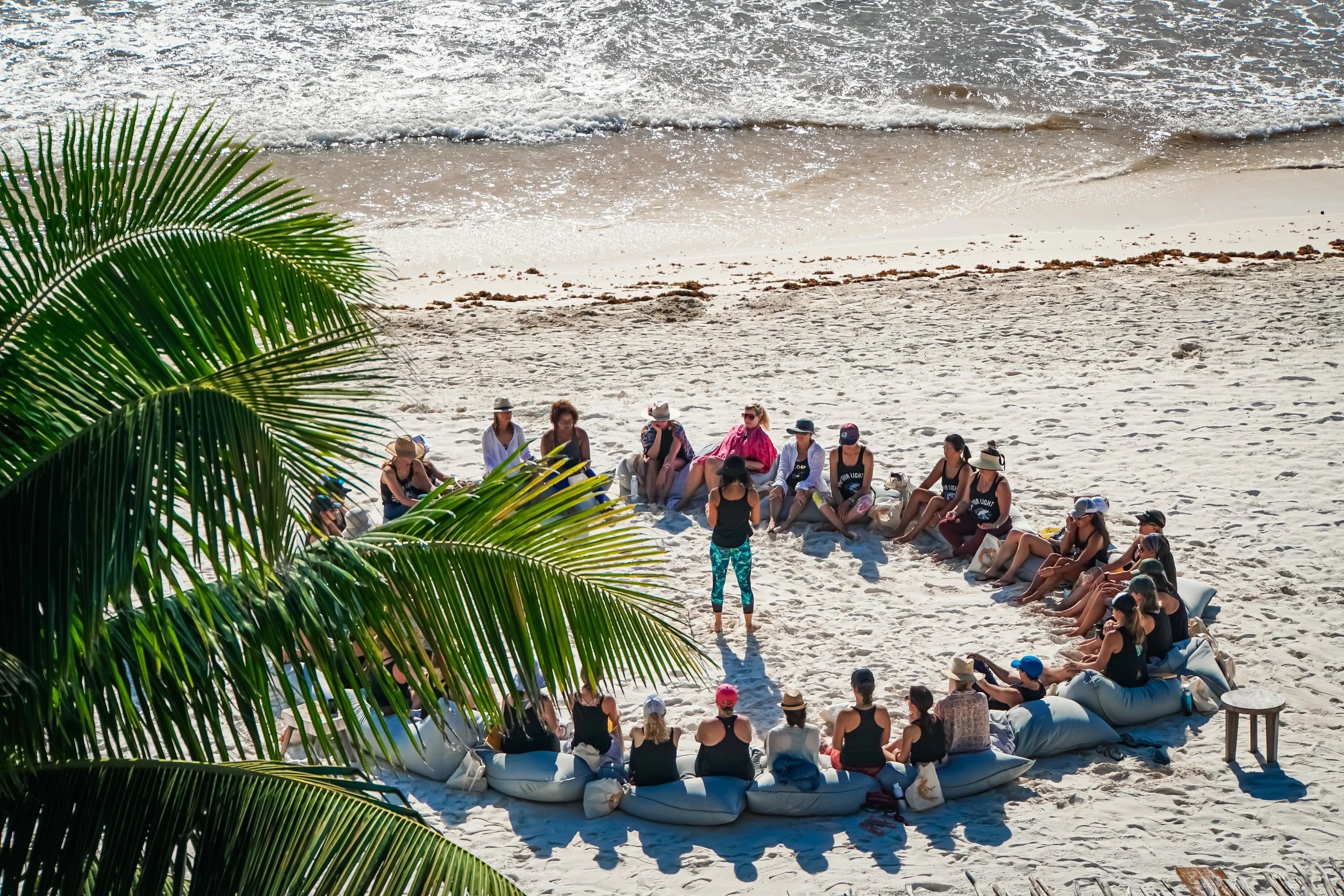 Beach yoga wellness circle at sunrise on the sand in Tulum, Mexico