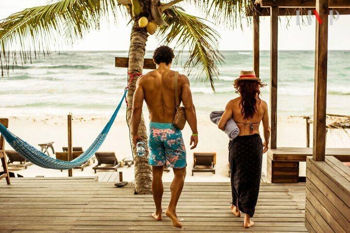 Beach fit couple exercising at Amansala Tulum