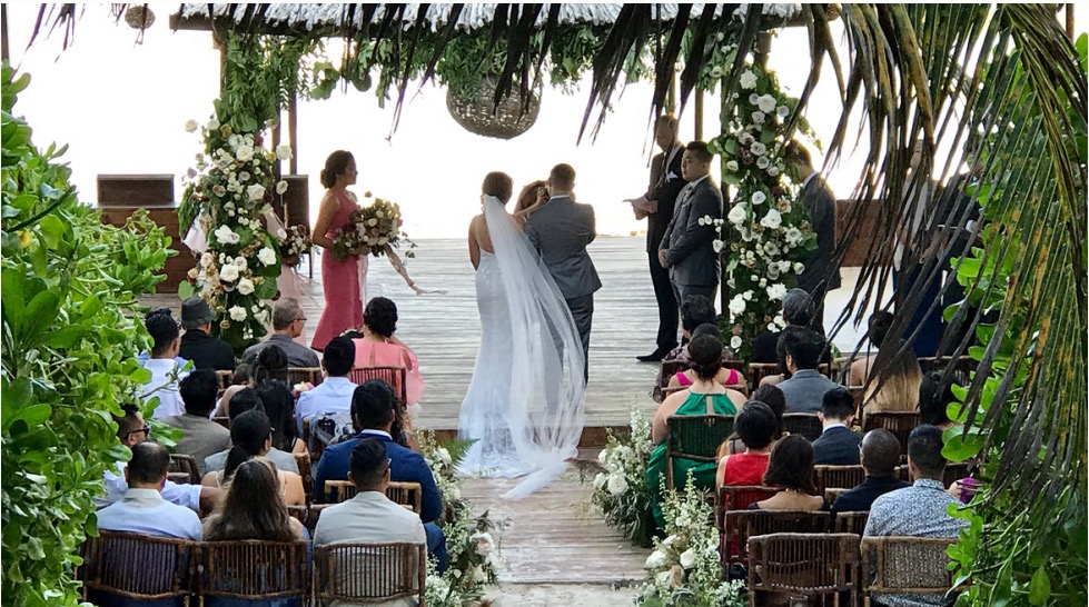 Walking down the aisle at a beach ceremony at Amansala Hotel Tulum