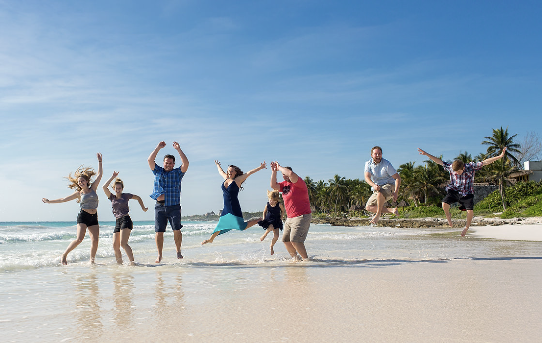 Family enjoying the beach at sunrise, feeling the benefits of a wellness retreat at Amansala, Tulum