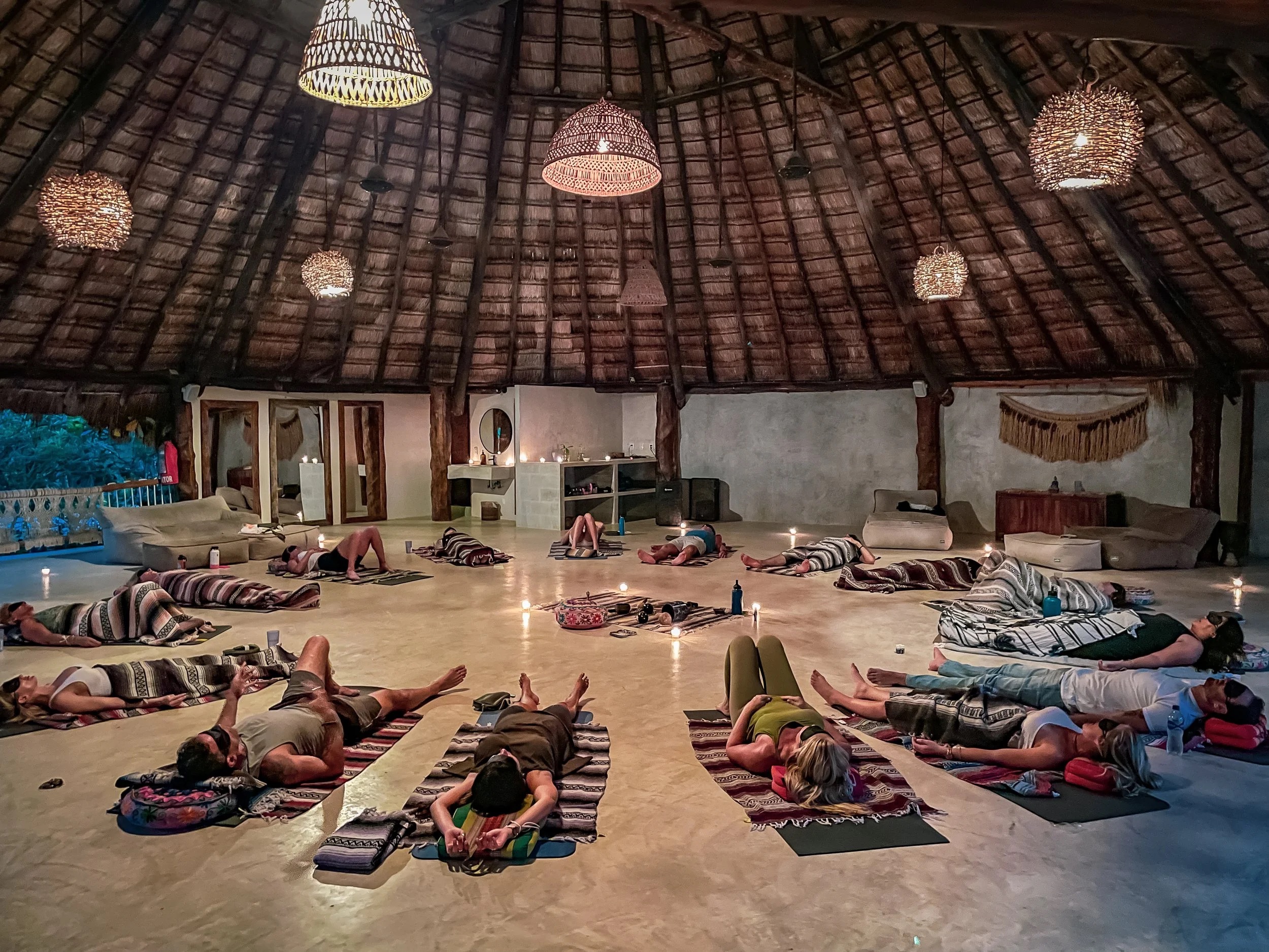 Cacao ceremony breathwork circle in an open-air shala at Amansala, Tulum