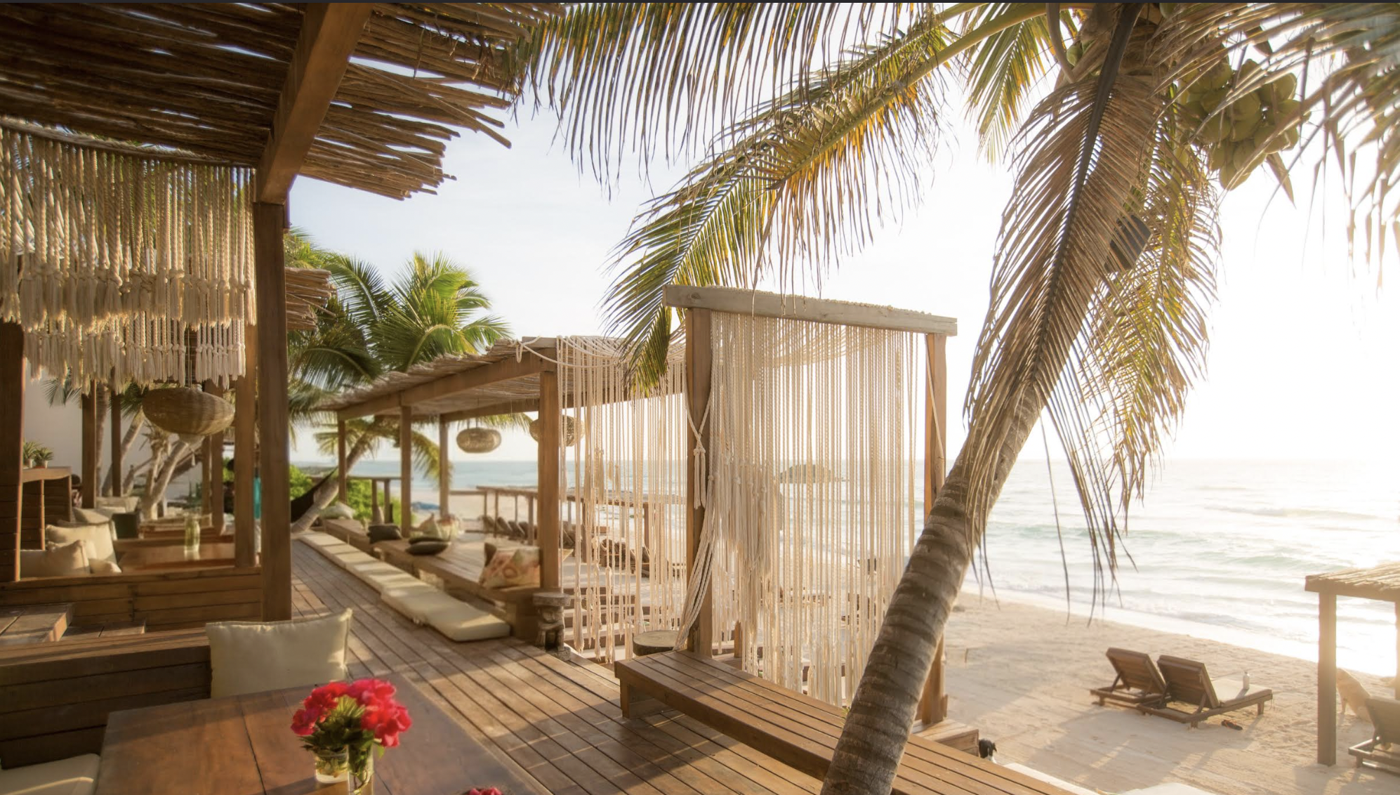 Palm-shaded beachfront deck at Amansala resort, Tulum, Mexico