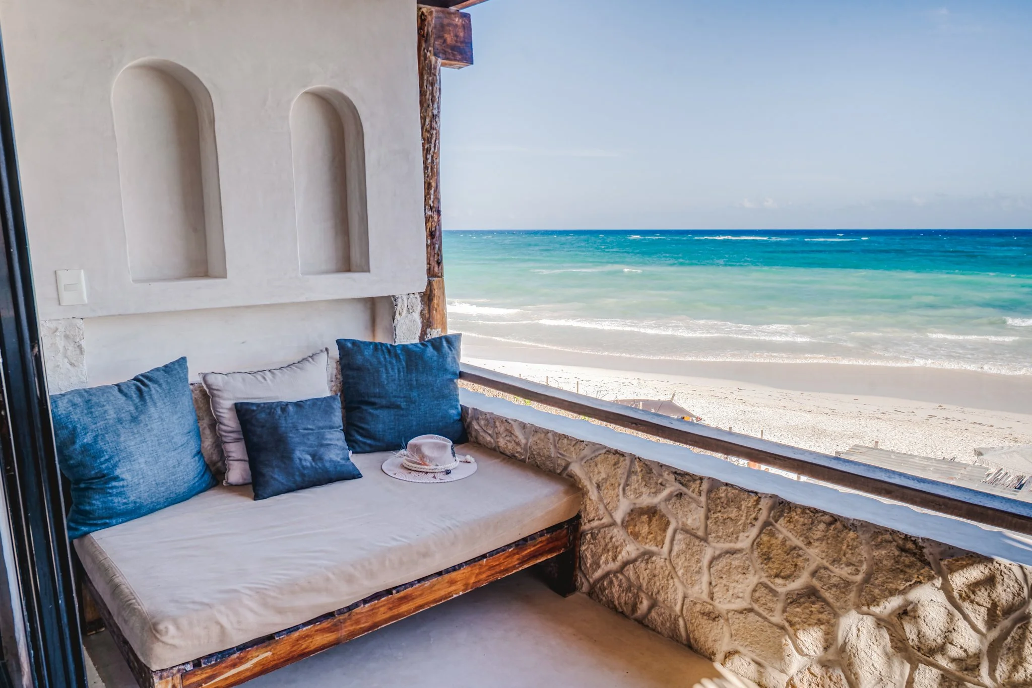 Oceanfront balcony lounge at Amansala, the celebrity favorite wellness resort in Tulum, Mexico