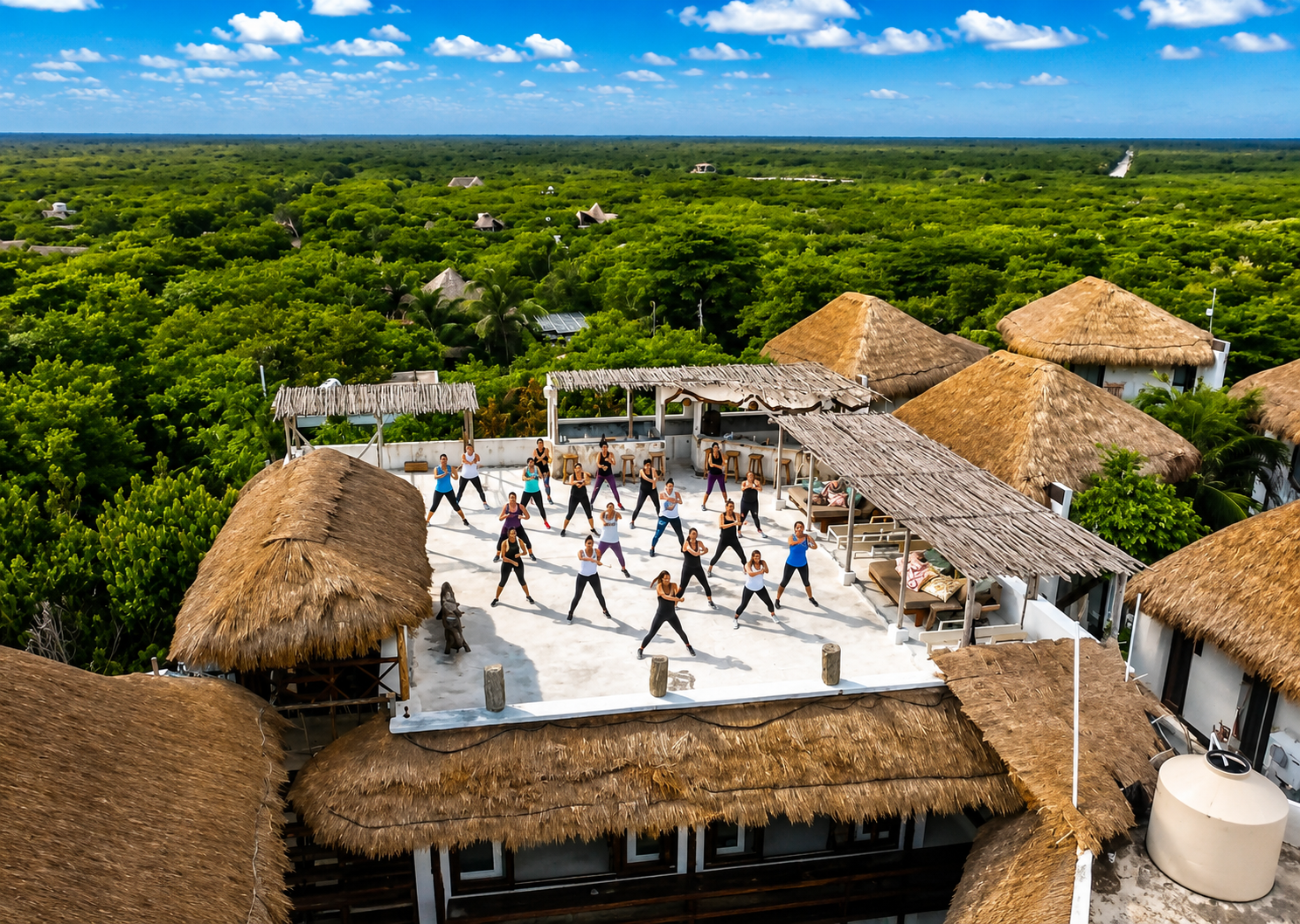 Aerial view of rooftop fitness class surrounded by jungle