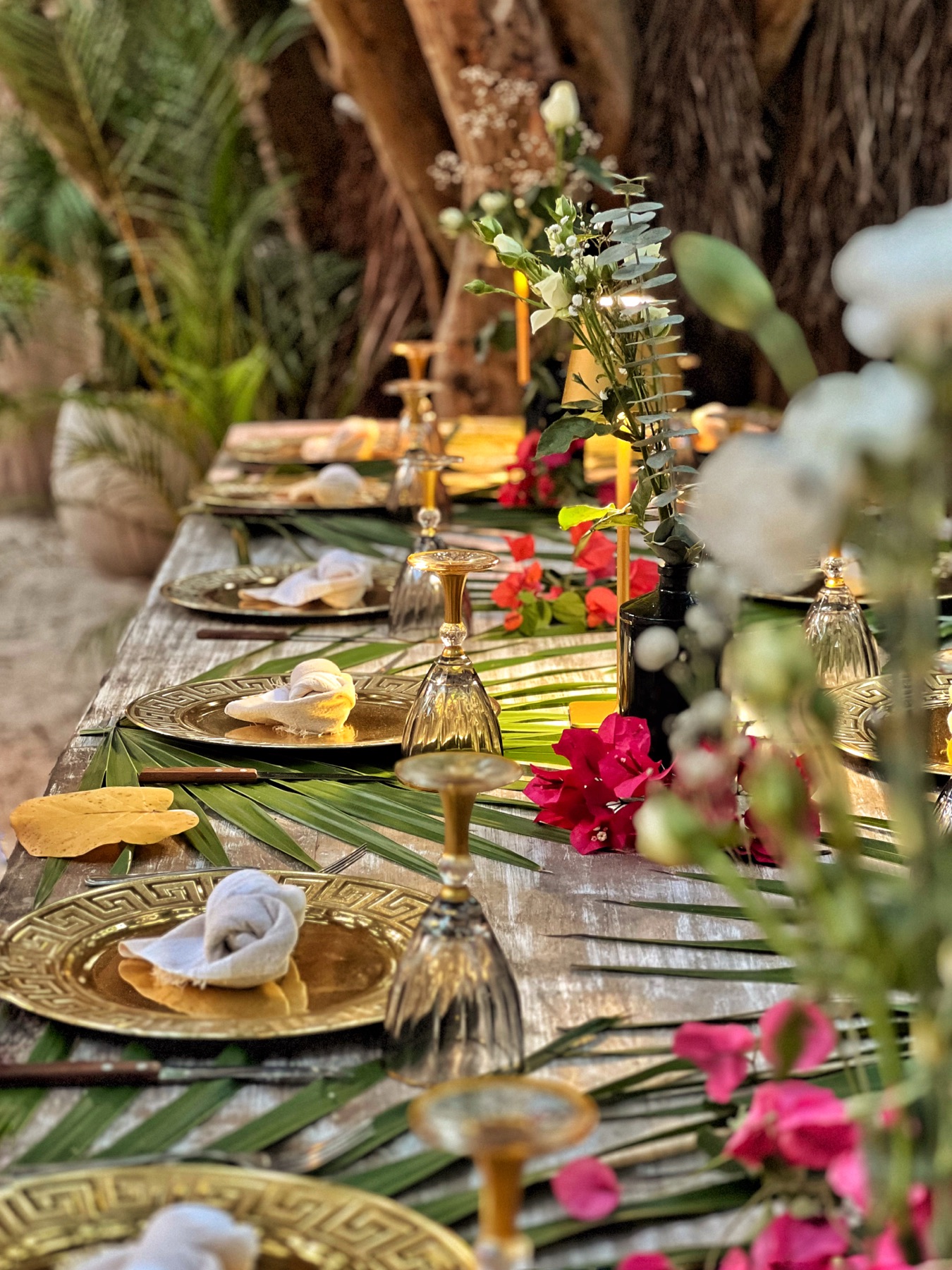 Gold table setting with tropical flowers